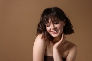 Brunette woman with a soft wolf cut with a textured, messy fringe